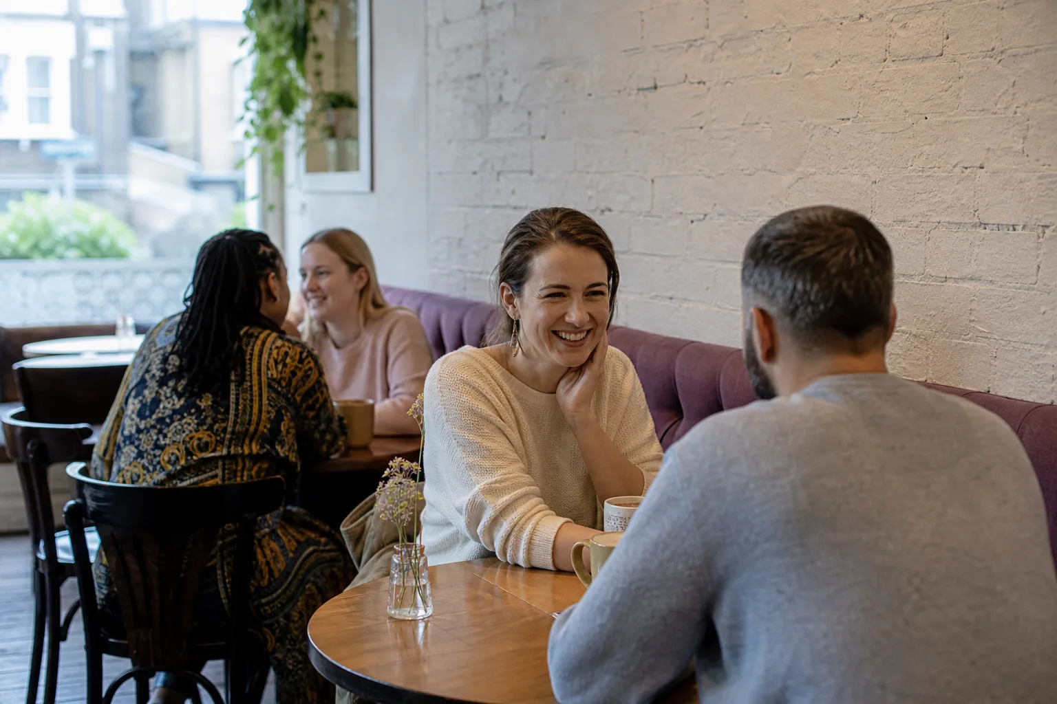 Woman creating an online dating profile at a café in Central Scotland